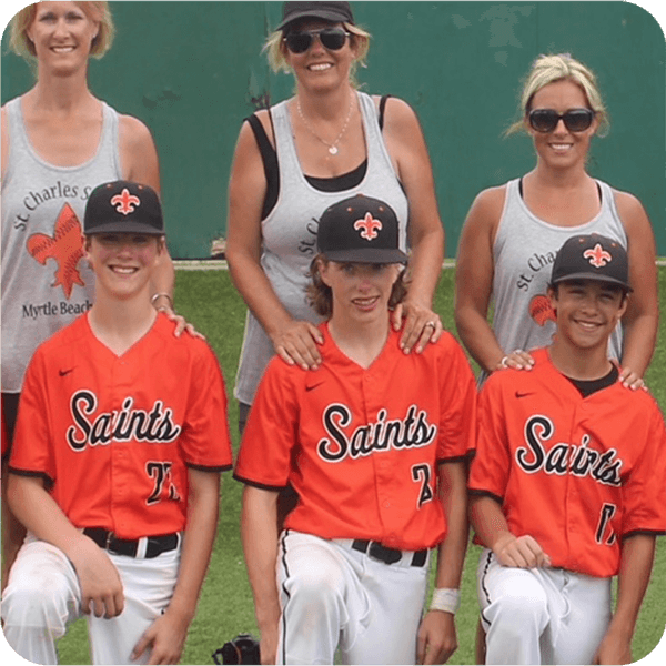 Young Kevin White in St. Charles Saints team. He is kneeling in a baseball field with his mom and teammates.